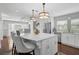 Bright kitchen with a marble island, pendant lighting, stainless steel appliances, and hardwood floors at 13514 4Th E Plz, Bradenton, FL 34212