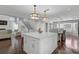 Spacious open-concept kitchen with marble island, seating, and hardwood floors that connect to a dining area at 13514 4Th E Plz, Bradenton, FL 34212