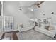 Sun-filled living area showcasing high ceilings, hardwood floors, and stairs to the second story at 13514 4Th E Plz, Bradenton, FL 34212