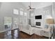 Bright living room featuring a stone fireplace, high ceilings, and multiple glass doors to outdoor area at 13514 4Th E Plz, Bradenton, FL 34212