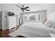Calm primary bedroom featuring a bay window, hardwood floors, walk in closet, and a dresser at 13514 4Th E Plz, Bradenton, FL 34212