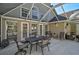 Charming covered patio features neutral tones, an outdoor dining set, and serene views of the surrounding landscape at 13514 4Th E Plz, Bradenton, FL 34212