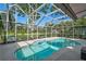 This in-ground pool with clear water features an enclosed screened cage with sunny sky views at 13514 4Th E Plz, Bradenton, FL 34212