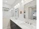Bright bathroom features double sink vanity with modern fixtures, framed mirrors, and walk-in shower at 13606 Deep Blue Pl, Bradenton, FL 34211