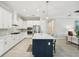 Modern kitchen featuring white cabinetry, stainless steel appliances, and center island with seating at 13606 Deep Blue Pl, Bradenton, FL 34211