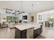 Beautiful kitchen features island with sink and stainless steel dishwasher overlooking living and dining rooms at 13606 Deep Blue Pl, Bradenton, FL 34211