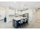 Modern kitchen featuring white cabinetry, stainless steel appliances, and center island with seating at 13606 Deep Blue Pl, Bradenton, FL 34211