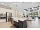 Open concept kitchen featuring stainless steel appliances, center island and view of great room at 13606 Deep Blue Pl, Bradenton, FL 34211