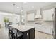 Modern kitchen featuring white cabinetry, stainless steel appliances, and center island with seating at 13606 Deep Blue Pl, Bradenton, FL 34211
