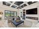 Comfortable living room with backyard access, fireplace, large television, and coffered ceilings at 13606 Deep Blue Pl, Bradenton, FL 34211