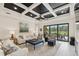 Comfortable living room with backyard access and view of the outdoor dining and pool at 13606 Deep Blue Pl, Bradenton, FL 34211