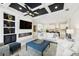 Spacious living room boasts coffered ceilings, fireplace, large tv, and views into kitchen at 13606 Deep Blue Pl, Bradenton, FL 34211