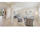 Bright living room with an open floor plan to the dining area with great lighting and plank flooring at 13606 Deep Blue Pl, Bradenton, FL 34211