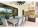 Covered outdoor dining area featuring a grill and outdoor kitchen setup for entertaining at 13606 Deep Blue Pl, Bradenton, FL 34211