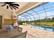 Outdoor kitchen and dining area provide space to enjoy backyard lake and pool views at 13606 Deep Blue Pl, Bradenton, FL 34211