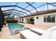 Beautiful screened-in pool area with lounge chairs, outdoor dining, and inviting pool at 13606 Deep Blue Pl, Bradenton, FL 34211