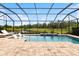 Enclosed backyard pool offers a relaxing view of the lake and features lounge chairs at 13606 Deep Blue Pl, Bradenton, FL 34211