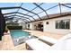 Relaxing screened-in pool area with sun loungers and outdoor dining, perfect for enjoying the Florida lifestyle at 13606 Deep Blue Pl, Bradenton, FL 34211