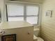Bathroom featuring a toilet and a window with white blinds at 1412 12Th W Ave, Bradenton, FL 34205