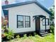 Charming home featuring a white exterior, black trim, and landscaped front yard at 1412 12Th W Ave, Bradenton, FL 34205
