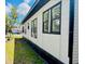 Exterior side view of the property showcasing fresh paint and manicured lawn at 1412 12Th W Ave, Bradenton, FL 34205