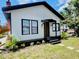 Well maintained one-story home featuring a cozy front porch and a small, well-maintained lawn at 1412 12Th W Ave, Bradenton, FL 34205