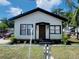 Charming single-story home with a cozy front porch and well-maintained lawn and a chain link fence at 1412 12Th W Ave, Bradenton, FL 34205