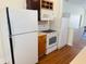 Kitchen featuring white appliances, wooden cabinets and ample counter space at 1412 12Th W Ave, Bradenton, FL 34205