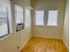 Cozy sunroom with hardwood floors and lots of light from the four windows at 1412 12Th W Ave, Bradenton, FL 34205