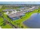 Expansive aerial view showcasing homes with pools, lush landscaping, and tranquil ponds in a well-planned community at 16606 Barnwood Pl, Lakewood Ranch, FL 34211