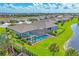 Scenic aerial view of homes with pools, surrounded by lush landscaping and tranquil ponds in a planned community at 16606 Barnwood Pl, Lakewood Ranch, FL 34211
