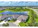 Overhead shot of home featuring a screened-in pool and picturesque view of the surrounding community and pond at 16606 Barnwood Pl, Lakewood Ranch, FL 34211