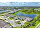 Beautiful aerial view of homes in a planned community surrounding a large pond and green spaces at 16606 Barnwood Pl, Lakewood Ranch, FL 34211