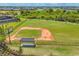 Overhead view of a well-kept baseball field, complete with covered dugouts and fencing at 16606 Barnwood Pl, Lakewood Ranch, FL 34211