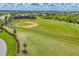 Aerial view of a community baseball field with dugouts surrounded by walking trails and sports facilities at 16606 Barnwood Pl, Lakewood Ranch, FL 34211