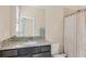 Well-lit bathroom featuring a granite countertop, modern sink, and shower with neutral accents at 16606 Barnwood Pl, Lakewood Ranch, FL 34211