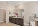 Bathroom features a double sink with granite countertops, and an adjacent doorway at 16606 Barnwood Pl, Lakewood Ranch, FL 34211