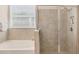 Bright bathroom featuring an enclosed glass shower next to a bathtub at 16606 Barnwood Pl, Lakewood Ranch, FL 34211