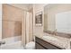 Bathroom showcases a vanity with a granite countertop, accompanied by a bathtub-shower combination at 16606 Barnwood Pl, Lakewood Ranch, FL 34211