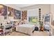 Cozy bedroom featuring a window with backyard views, decorated with music posters and vinyl records at 16606 Barnwood Pl, Lakewood Ranch, FL 34211
