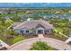 A beautiful clubhouse exterior is enhanced by colorful landscaping and a circular brick drive at 16606 Barnwood Pl, Lakewood Ranch, FL 34211