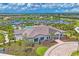 A beautifully landscaped clubhouse featuring a tile roof, detailed facade, and manicured grounds at 16606 Barnwood Pl, Lakewood Ranch, FL 34211