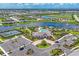 Aerial view of a modern clubhouse with a pool, parking and beautifully landscaped grounds at 16606 Barnwood Pl, Lakewood Ranch, FL 34211