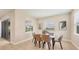 Bright dining room featuring a glass table, tan chairs, and a view of the water through large windows at 16606 Barnwood Pl, Lakewood Ranch, FL 34211