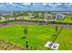 Well-maintained community dog park with lush green grass, seating area and convenient waste disposal station at 16606 Barnwood Pl, Lakewood Ranch, FL 34211