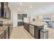 Well-equipped kitchen with stainless steel appliances, granite countertops, and seamless access to the living area at 16606 Barnwood Pl, Lakewood Ranch, FL 34211