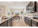 Modern kitchen showcasing granite countertops, dark cabinets, and a breakfast nook with scenic views at 16606 Barnwood Pl, Lakewood Ranch, FL 34211