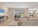 Inviting living room with tile floors, a modern fireplace, and sliding glass doors leading to the outdoor area at 16606 Barnwood Pl, Lakewood Ranch, FL 34211
