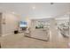 Bright living room with tile flooring, sliding glass doors to the outside, and a cozy sectional sofa at 16606 Barnwood Pl, Lakewood Ranch, FL 34211