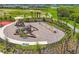 A fun, safe playground with slides and climbing equipment surrounded by lush landscaping at 16606 Barnwood Pl, Lakewood Ranch, FL 34211